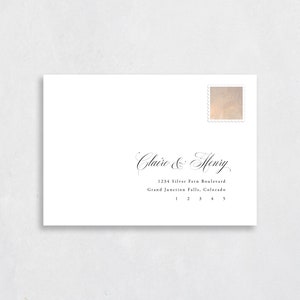 May include: White envelope with a decorative stamp in the upper right corner. The envelope is addressed to Claire & Henry, 1234 Silver Fern Boulevard, Grand Junction Falls, Colorado.