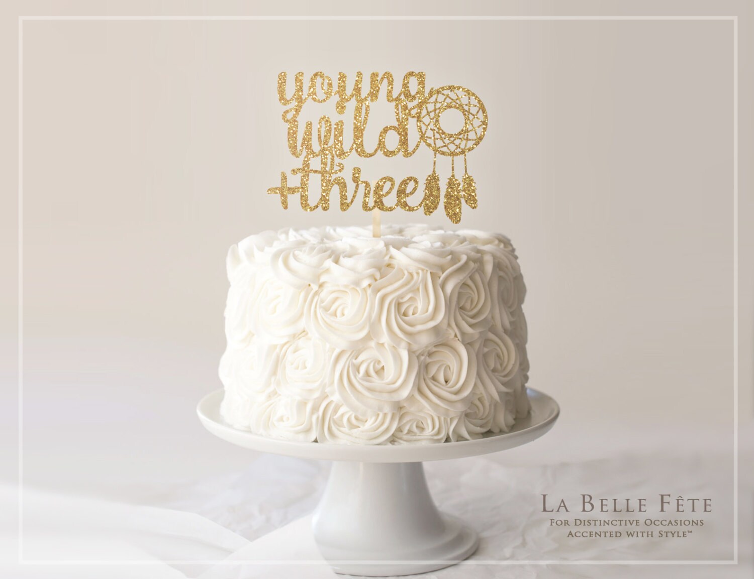 YOUNG, WILD + THREE gold glitter cake topper with dream catcher for b…