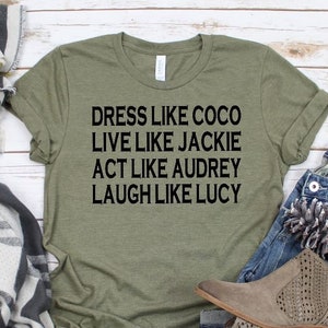 May include: Green t-shirt with the text "Dress like Coco, Live like Jackie, Act like Audrey, Laugh like Lucy" printed in black.