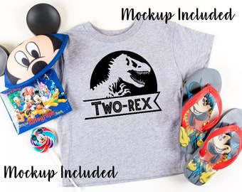 May include: Gray t-shirt with a black silhouette of a dinosaur and the text "TWO-REX". The shirt is a mockup and is shown with a Mickey Mouse hat, a lollipop, and a book.