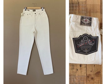 May include: White high-waisted jeans with a contour fit. The jeans have a label on the back pocket that says "Contour Fit Jeans" and "Exp. Jeans".