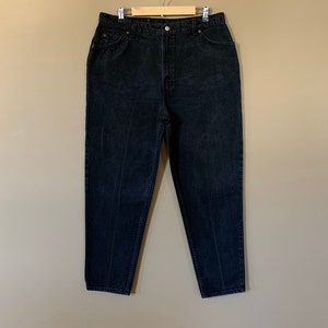 May include: Black high-waisted jeans with a straight leg fit.