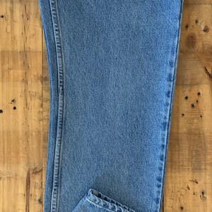 May include: A pair of light blue denim jeans with a straight leg and a classic fit.
