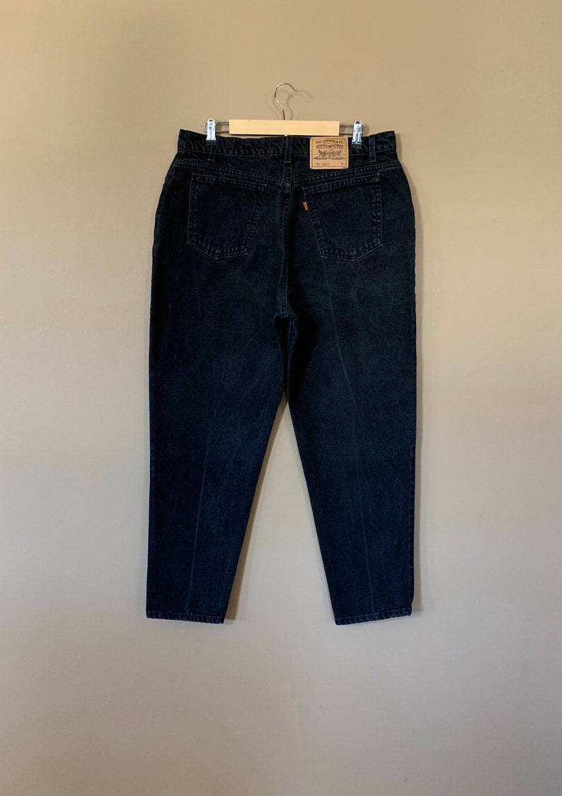May include: Black denim jeans with a Levi's brand label on the back pocket.