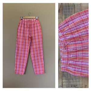May include: Pink and orange plaid pants with a high waist and a relaxed fit.