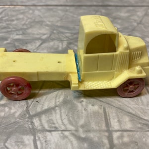 Vintage MACK Truck Cab and Trailer are Yellow with Pinkish Red Wheels