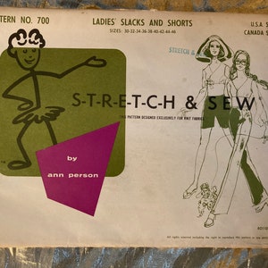 May include: A vintage sewing pattern for ladies' slacks and shorts, featuring a cartoon illustration of a stick figure wearing a tutu and the text "S-T-R-E-T-C-H & SEW". The pattern is designed exclusively for knit fabrics and is by Ann Person.
