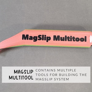 May include: A pink, green, and yellow multitool with the text "MagSlip Multitool" printed on it. The multitool is designed for building the MagSlip system.