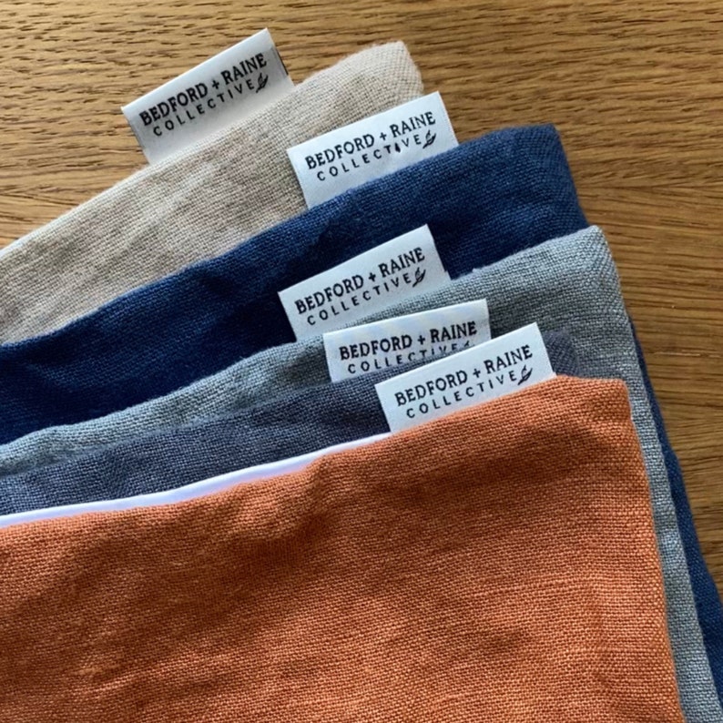 Showing the color options for linen and satin pillowcases: Orange, Indigo Blue, Grey, Charcoal, White, and Beige.