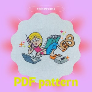 May include: Cross-stitch pattern featuring a cartoon character with blonde hair, wearing glasses, a pink top, and blue shorts, lounging with a phone, book, laptop, and a pretzel. The text "PDF pattern" is at the bottom.