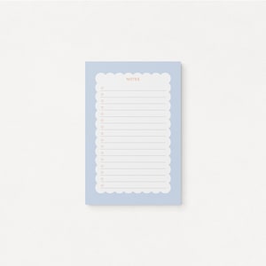 May include: A light blue notepad with a scalloped edge and the word "NOTES" printed at the top. The notepad has a white background with black lines and orange circles.