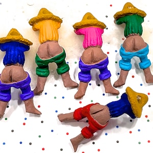 Può includere: Una collezione di figurine stravaganti che raffigurano figure con i glutei esposti, che indossano camicie, pantaloni e cappelli di paglia colorati. Le figurine sono dipinte in vari colori, tra cui blu, verde, rosa, arancione e rosso.