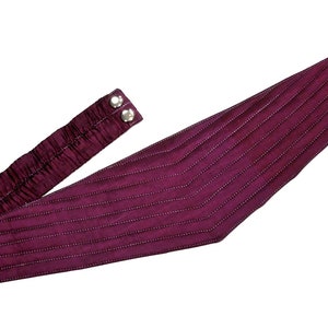 May include: A burgundy quilted fabric belt with a buckle and two silver buttons.