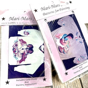May include: Two packages of Mari-Mars patterns for painting. Each package includes a color photo and painting instructions. The patterns feature Native American designs on a white and gray shirt.