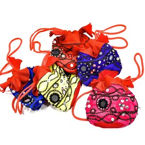May include: Five colourful drawstring bags with beaded embellishments and mirror accents. The bags are red, pink, blue, yellow, and purple.
