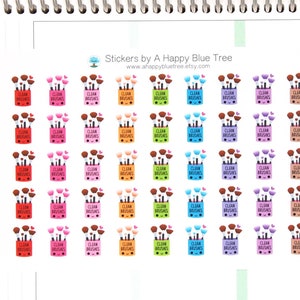 Op de afbeelding: Een vel met 49 kleurrijke stickers met een cartoonillustratie van een make-upkwastendoos met de tekst "Clean Brushes". De stickers zijn in een rasterpatroon gerangschikt.