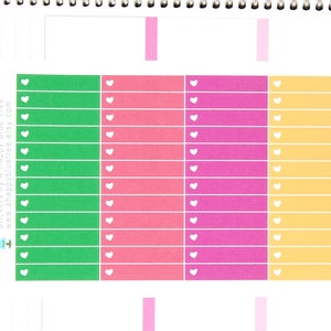 May include: A sheet of colorful planner stickers with white hearts. The stickers are in green, pink, light pink, and yellow. The stickers are labeled with the days of the week: Thursday, Friday, Saturday, Sunday, and Monday.