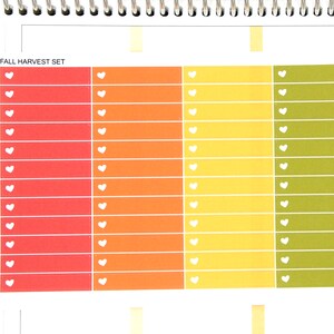 May include: A set of 18 fall-themed planner stickers with a heart design. The stickers are in shades of red, orange, yellow, and green. The text "FALL HARVEST SET" is at the top of the image.