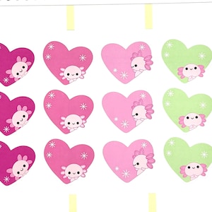 May include: A sheet of heart-shaped stickers in shades of pink and green, each featuring a cute axolotl illustration. The stickers are arranged in rows and columns, perfect for planners or crafts.