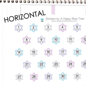 May include: A set of 31 snowflake stickers with numbers 1 through 31. The stickers are in various colors, including pink, blue, and white. The stickers are arranged in a calendar format, with the days of the week listed on the right side of the image. The text "HORIZONTAL" is at the top of the image. The text "Stickers by A Happy Blue Tree" is in the upper right corner of the image. The text "www.ahappybluetree.etsy.com" is below the text "Stickers by A Happy Blue Tree".
