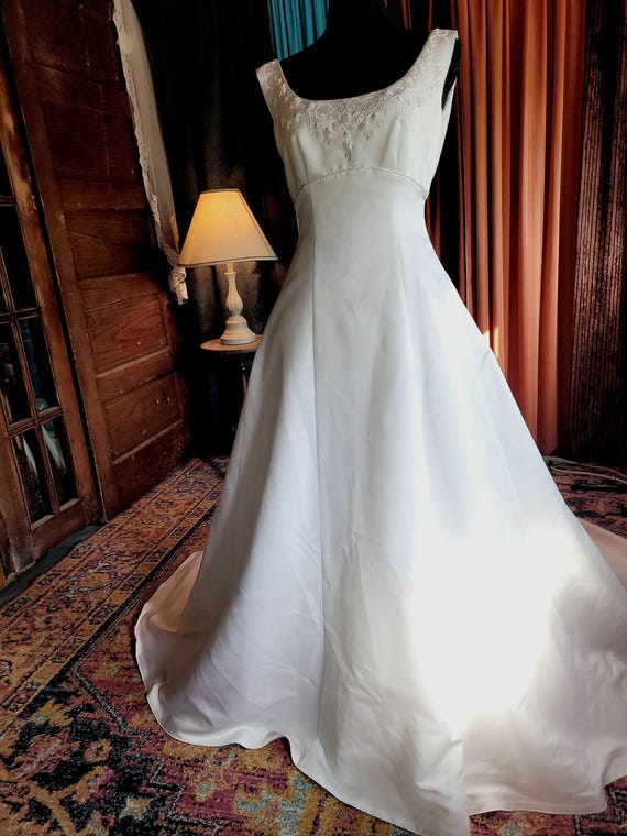 1995 white matte satin Jasmine wedding gown with a cathedral veil.