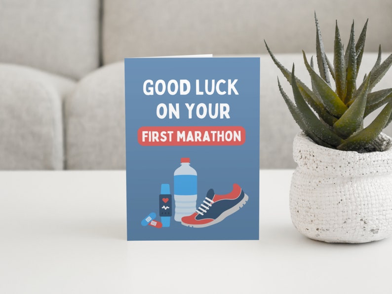 Men's first marathon good luck card in blue and red on sideboard