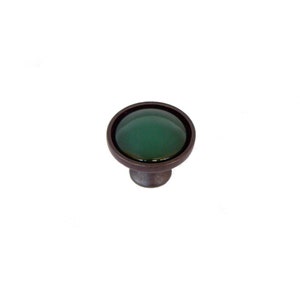 May include: A round, green glass cabinet knob with a dark bronze finish.