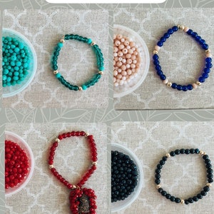May include: A selection of beaded scapular bracelets in various colors, including turquoise, peach, blue, red, and black. The image text reads "Beaded Scapular Bracelets" and "2. Choose Your Color".