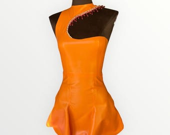 May include: Bright orange, one-shoulder dress with a high neckline and a flared skirt. The dress features a decorative beaded detail along the shoulder strap. The dress is displayed on a mannequin.