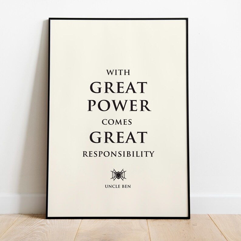 May include: A rectangular wall art print in a thin black frame featuring a cream-colored background with black text that reads: WITH GREAT POWER COMES GREAT RESPONSIBILITY. Below the text is a small black spiderweb icon and the name UNCLE BEN.
