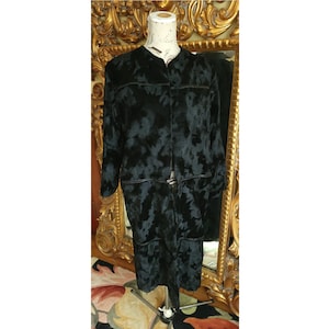 May include: A black velvet coat with a floral pattern. The coat has a long, fitted silhouette and a high collar.