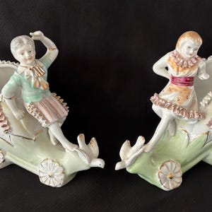 Antique Pair Bone China Lace Boy & Girl Riding in Fantasy Flower Carts Figural Vases