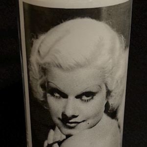 May include: A black and white photo of a woman with blonde hair is printed on a clear glass tumbler.