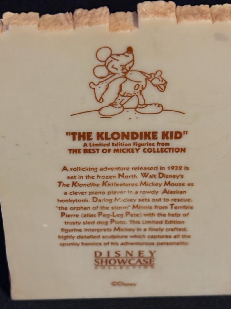 May include: A limited edition figurine from the Best of Mickey Collection, featuring Mickey Mouse in "The Klondike Kid." The figurine depicts Mickey in a finely crafted, detailed sculpture. The text on the figurine describes the story.
