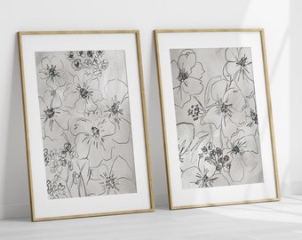 May include: Two framed prints with black and white line drawings of flowers on a light gray background.
