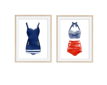 May include: Two framed watercolour prints of vintage swimwear. One shows a navy blue swimsuit with gold buttons and white trim. The other depicts a red high-waisted bikini with white buttons and a blue and white striped halter top.