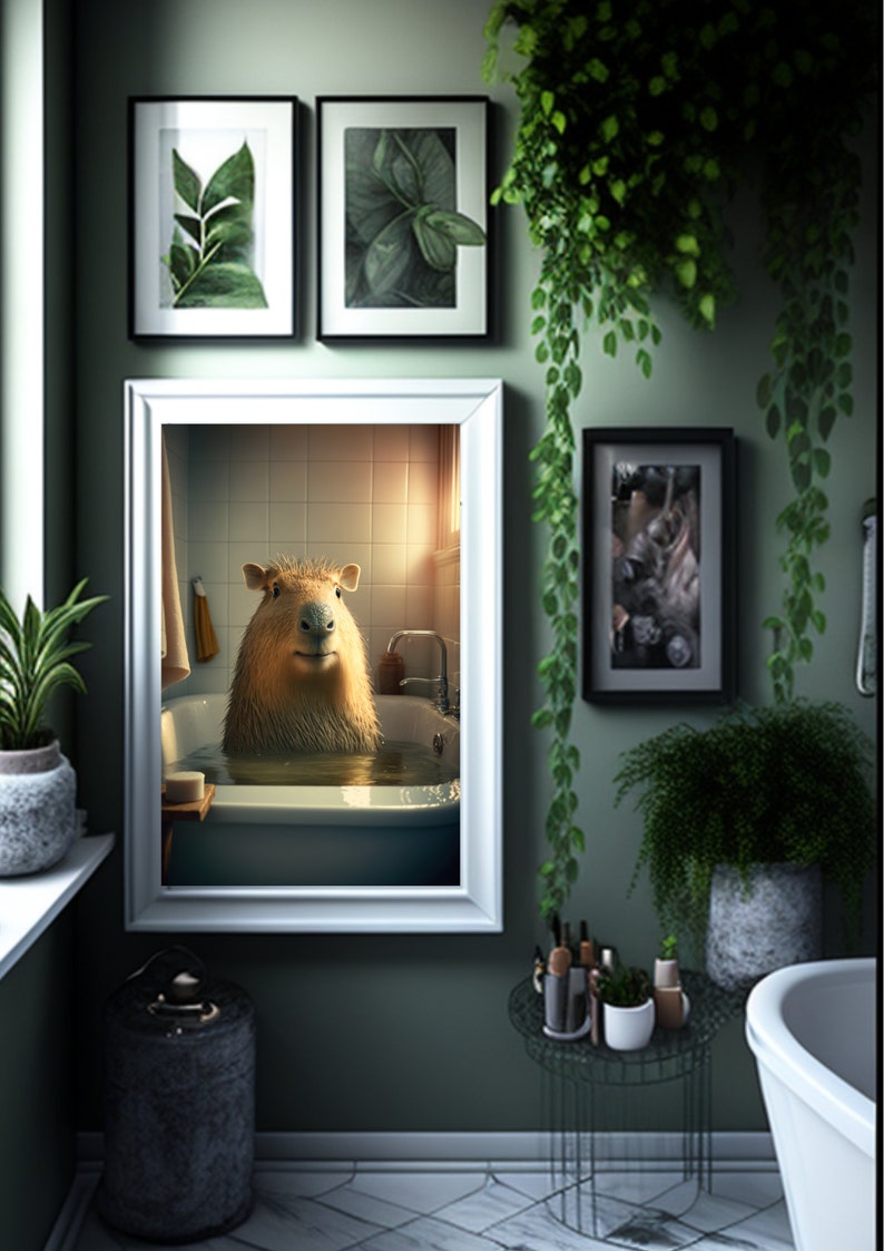 May include: A white framed picture of a capybara taking a bath in a white bathtub. The picture is hanging on a green wall with other framed pictures and plants.