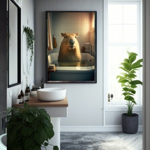 May include: A framed print of a capybara taking a bath in a white bathtub. The capybara is looking directly at the camera with a relaxed expression. The bathroom is tiled in white and has a window with a view of the outside.