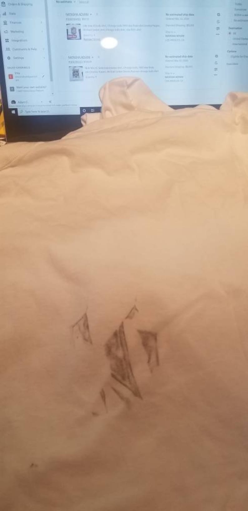 May include: A white t-shirt with a faint gray pencil drawing of a mountain range on the front.