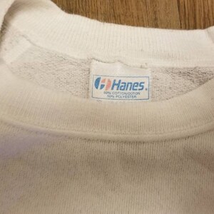 May include: White Hanes sweatshirt with a blue tag that reads "Hanes" and "60% Cotton/40% Polyester".