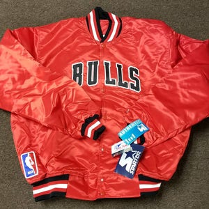 May include: Red satin baseball jacket with black and white striped cuffs and collar. The jacket has a large "BULLS" logo on the front and a Starter logo patch on the right sleeve. The jacket also has an NBA logo patch on the left sleeve.