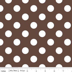 May include: Brown fabric with a repeating pattern of large white polka dots. The fabric has a ruler along the bottom edge, with the text "Riley Blake Designs" at the bottom.