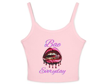 May include: Pink spaghetti strap crop top with the word "Bae" above a graphic of red lips with gold teeth and a diamond. The word "Everyday" is below the lips.