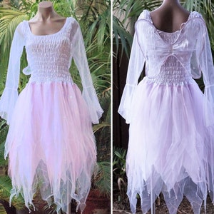 May include: A white and pink fairy costume with sheer fabric and a tulle skirt. The costume includes a pair of attached wings.