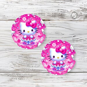 May include: Two pink and white Hello Kitty coasters with a pink background and white hearts. The coasters feature a cartoon image of Hello Kitty wearing a pink dress and a pink bow.