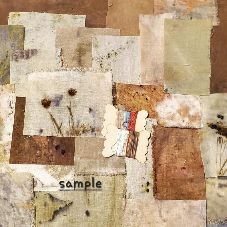 May include: A collection of fabric squares in various shades of brown, beige, and green, with a few darker brown spots. The fabric squares are arranged in a patchwork pattern. Two wooden spools of thread are in the lower center of the image. The word "sample" is printed in black on a white fabric square in the lower center of the image.