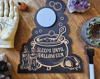 Cartello per il conto alla rovescia di Halloween: lavagna bianca con calderone per pozioni, decorazione spettrale
