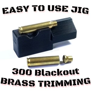 May include: A black jig with a brass cartridge in place, and a separated cartridge below. The text "EASY TO USE JIG" and "300 Blackout BRASS TRIMMING" are displayed in bold, stencil-style font.