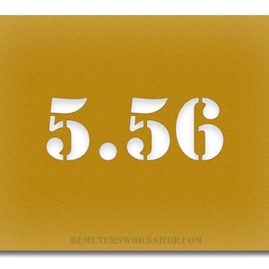 May include: Mustard-coloured stencil featuring the number "5.56" cut out in white. The text "DEMETERSWORKSHOP.COM" is printed in white at the bottom. The stencil is rectangular with a textured surface.