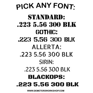 May include: A white background with black text showcasing different font styles. The text reads "PICK ANY FONT:" followed by font names like "STANDARD," "GOTHIC," and "BLACKOPS." Each font displays the text ".223 5.56 300 BLK."